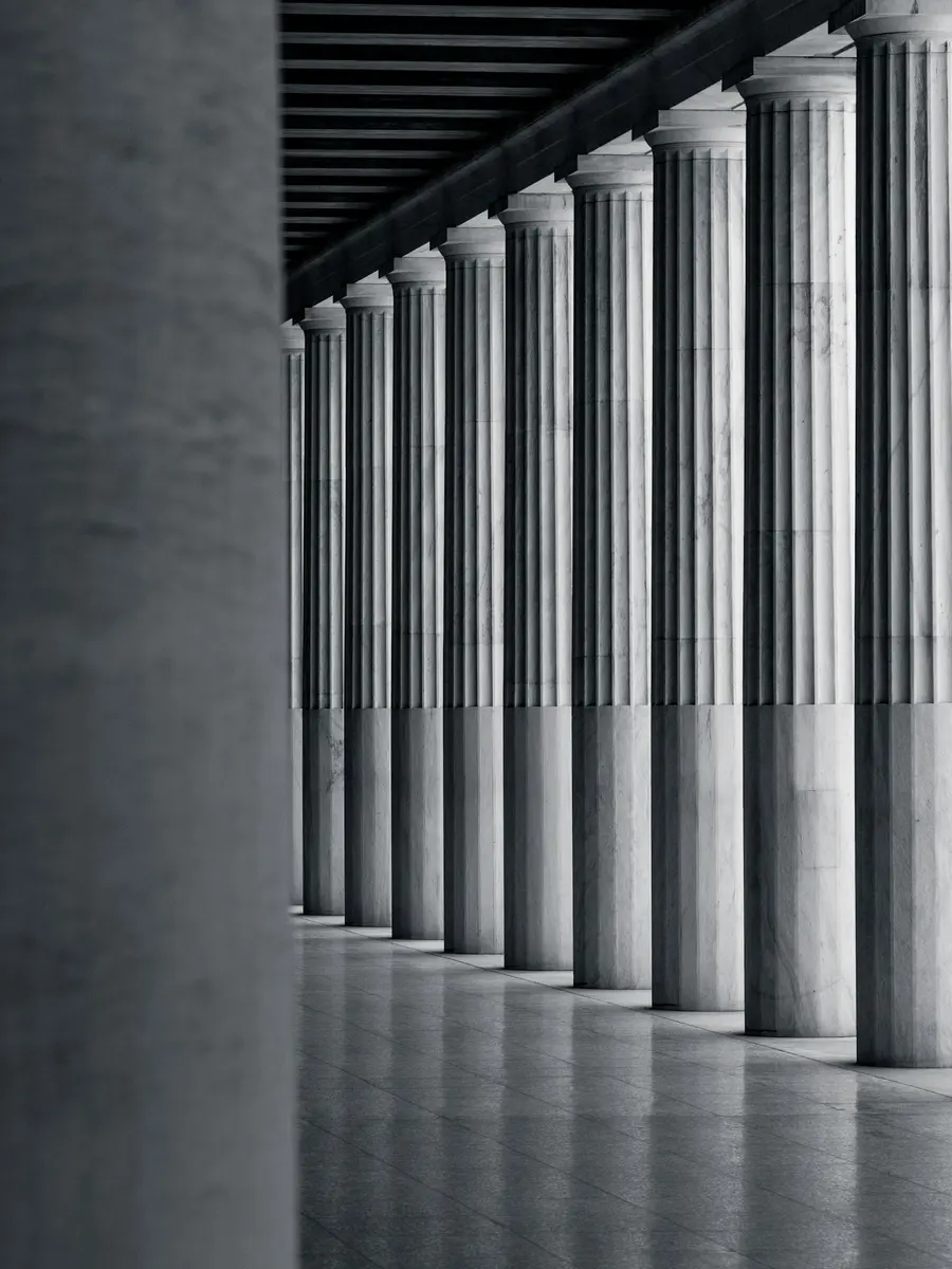 A long colonnade of white stone columns